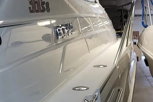 Slide: The Image of 2000 Doral 360 SE boat in storage, showcasing sleek white exterior and polished details. - 25