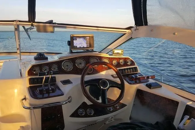 Slide: The Image of Cockpit view of a 2000 Doral 360 SE boat with navigation equipment and ocean backdrop. - 5