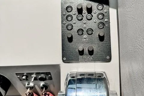 Slide: The Image of Control panel of a 1979 Wellcraft Scarab 38 boat with switches and levers. - 10