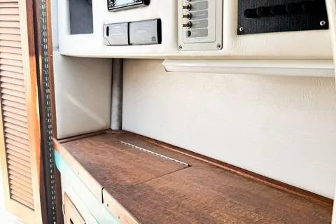 Slide: The Image of 1979 Wellcraft Scarab 38 interior with control panel and wooden surface. - 15