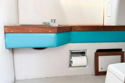 Slide: The Image of 1979 Wellcraft Scarab 38 interior with turquoise accents and wooden trim. - 16