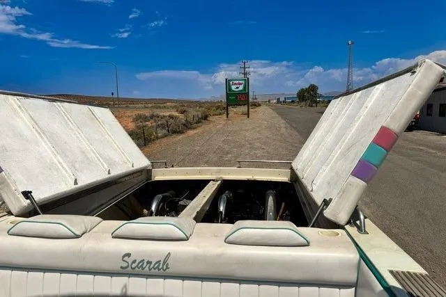 Slide: The Image of 1979 Wellcraft Scarab 38 with open engine hatches on a sunny roadside. - 18
