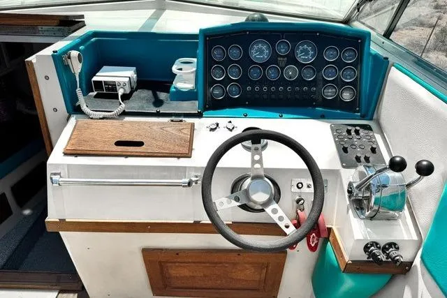 Slide: The Image of 1979 Wellcraft Scarab 38 boat dashboard with steering wheel and control panel. - 19
