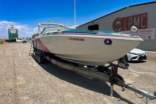 Slide: The Image of 1979 Wellcraft Scarab 38 boat on trailer, parked near storage facility. - 2