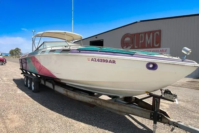 Slide: The Image of 1979 Wellcraft Scarab 38 boat on trailer, parked outdoors near a building. - 3