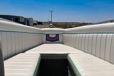 Slide: The Image of 1979 Wellcraft Scarab 38 boat interior with white seating and colorful accents under a clear blue sky. - 5