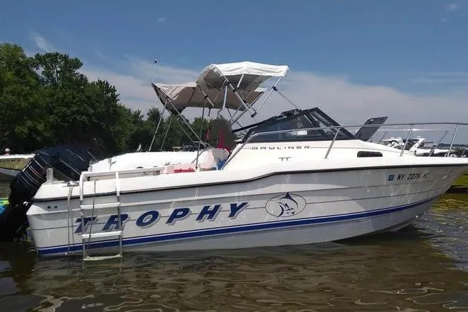 Slide: The Image of White 1993 Trophy 2002 Wa boat docked on a sunny day. - 1