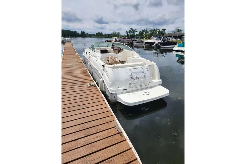 Slide: The Image of 2002 Sea Ray 260 Sundancer docked at marina, rear view. - 17