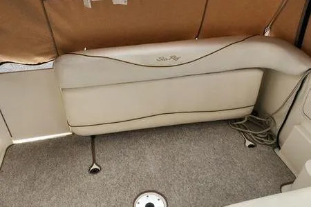 Slide: The Image of 2002 Sea Ray 260 Sundancer interior with beige seating and carpeted floor. - 18