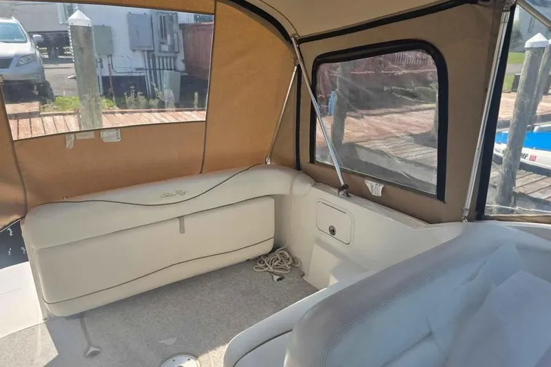 Slide: The Image of Interior view of a 2002 Sea Ray 260 Sundancer boat with beige seating and canopy. - 19