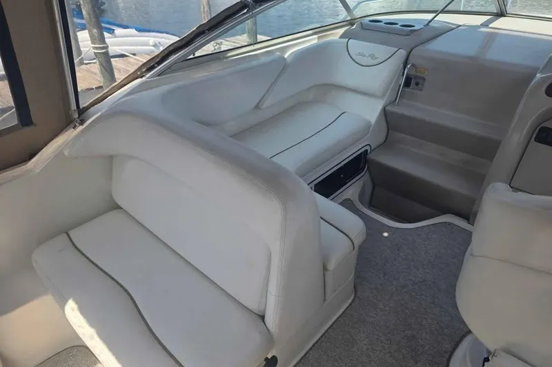 Slide: The Image of Interior of 2002 Sea Ray 260 Sundancer boat with white seating and helm. - 20