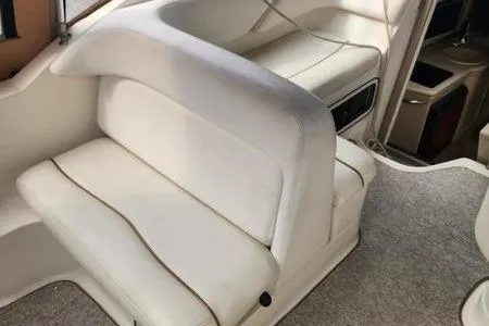 Slide: The Image of 2002 Sea Ray 260 Sundancer interior with white seating and carpeted flooring. - 21