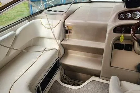 Slide: The Image of 2002 Sea Ray 260 Sundancer interior with beige seating and dashboard. - 23