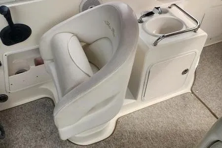Slide: The Image of 2002 Sea Ray 260 Sundancer interior with swivel seat and compact sink. - 24