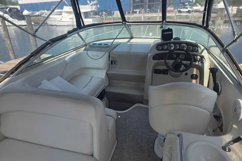 Slide: The Image of 2002 Sea Ray 260 Sundancer boat interior with steering wheel and seating. - 25