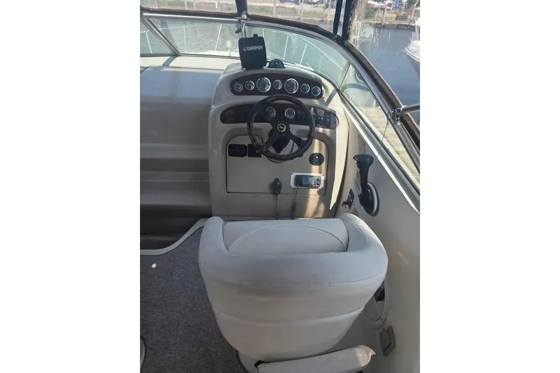 Slide: The Image of 2002 Sea Ray 260 Sundancer helm with steering wheel and navigation equipment. - 26