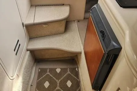 Slide: The Image of 2002 Sea Ray 260 Sundancer interior with steps and compact fridge. - 29