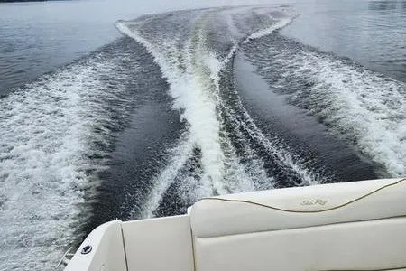 Slide: The Image of Wake trail behind a 2002 Sea Ray 260 Sundancer on calm water. - 3