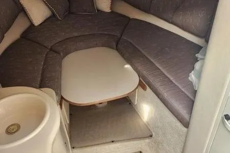 Slide: The Image of 2002 Sea Ray 260 Sundancer cabin interior with seating and table. - 30