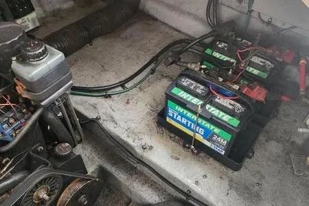 Slide: The Image of Engine compartment of a 2002 Sea Ray 260 Sundancer with batteries and mechanical components. - 42