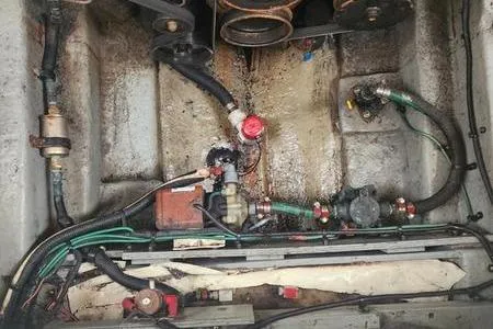 Slide: The Image of Engine compartment of a 2002 Sea Ray 260 Sundancer with visible wiring and components. - 43