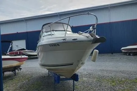 Slide: The Image of 2002 Sea Ray 260 Sundancer boat on display in a marina storage area. - 6