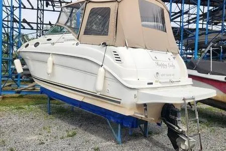 Slide: The Image of 2002 Sea Ray 260 Sundancer boat on dry dock with beige canopy. - 7
