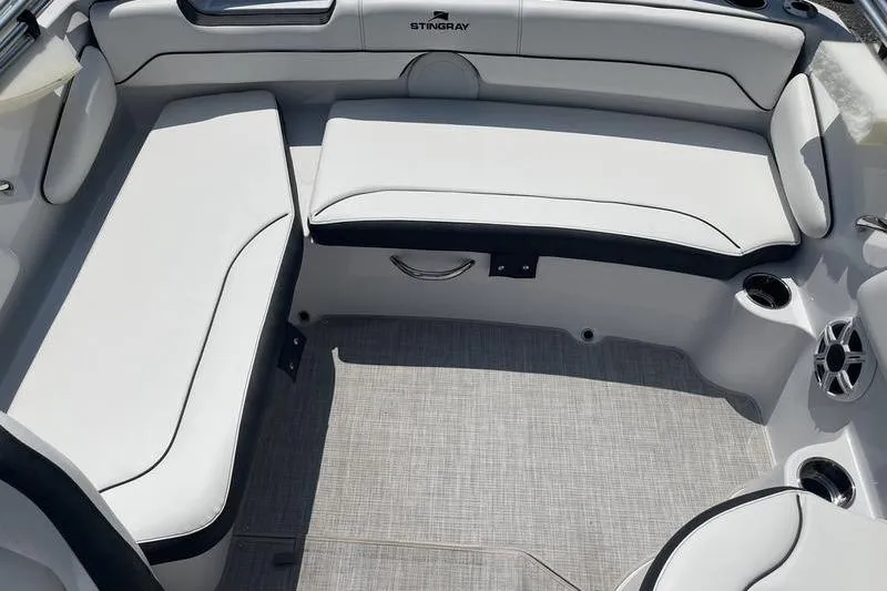 Slide: The Image of 2025 Stingray 182C boat interior with white cushioned seating and cup holders. - 10
