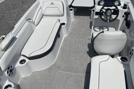 Slide: The Image of 2025 Stingray 182C boat interior with sleek seating and modern steering console. - 11