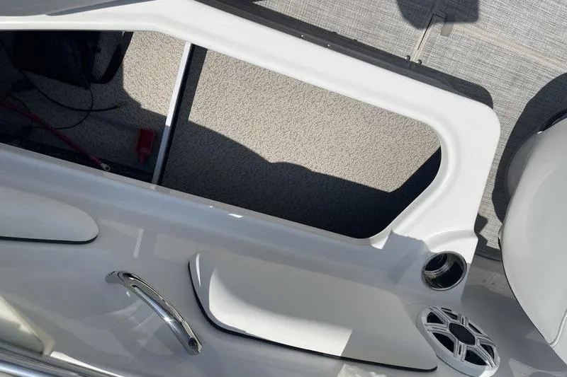 Slide: The Image of 2025 Stingray 182C boat interior with open storage compartment and speaker. - 14
