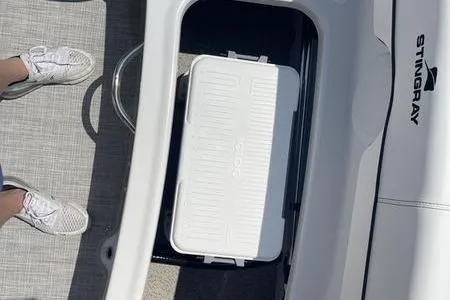 Slide: The Image of 2025 Stingray 182C boat interior with storage compartment and cooler. - 15
