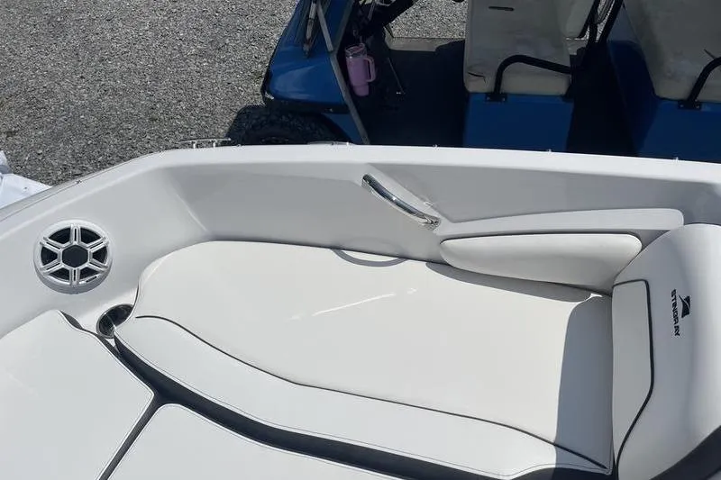 Slide: The Image of 2025 Stingray 182C boat interior with white seating and speaker detail. - 18