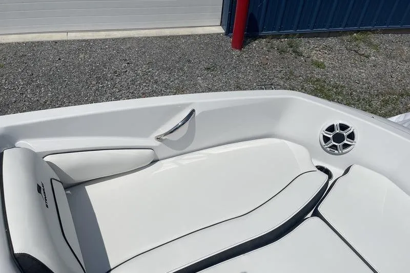 Slide: The Image of 2025 Stingray 182C boat interior with white seating and speaker detail. - 19