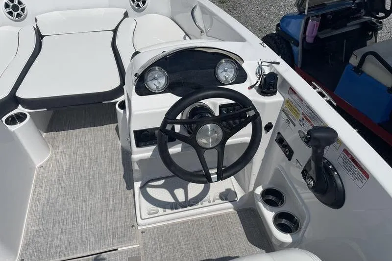 Slide: The Image of 2025 Stingray 182C boat cockpit with steering wheel and control panel. - 6