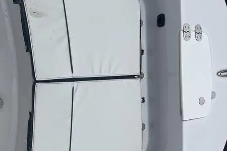 Slide: The Image of 2025 Stingray 173CC boat interior with white cushioned seating and storage compartments. - 11