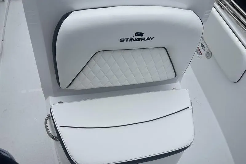 Slide: The Image of 2025 Stingray 173CC boat seat with white quilted upholstery and logo. - 14