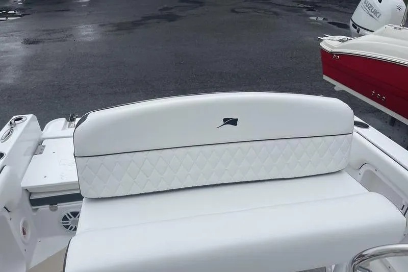 Slide: The Image of 2025 Stingray 173CC boat with white quilted seating, parked on wet pavement. - 15