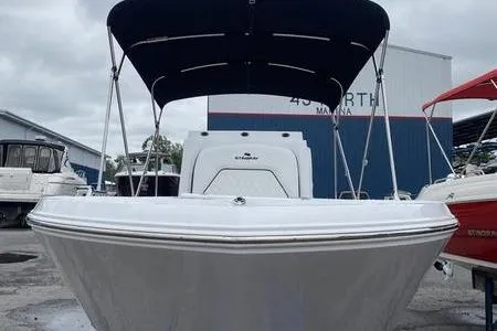 Slide: The Image of 2025 Stingray 173CC boat with canopy at marina, front view. - 3