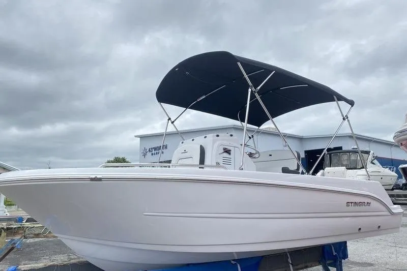 Slide: The Image of 2025 Stingray 173CC boat with canopy, displayed outdoors under cloudy skies. - 4