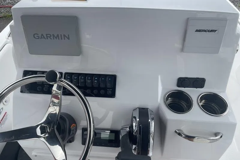 Slide: The Image of 2025 Stingray 173CC boat dashboard with Garmin and Mercury controls, steering wheel, and cup holders. - 9