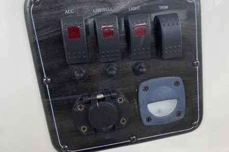 Slide: The Image of Control panel of a 2007 Stingray 195FX boat with switches and outlets. - 12