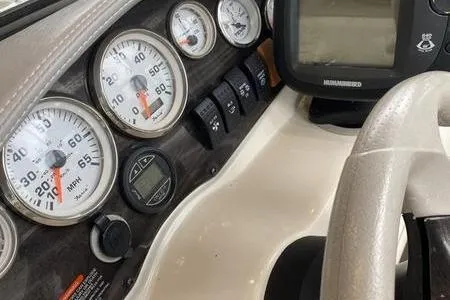 Slide: The Image of Dashboard of a 2007 Stingray 195FX boat with gauges and controls. - 16