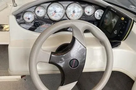 Slide: The Image of Steering wheel and dashboard of a 2007 Stingray 195FX boat with gauges and controls. - 17