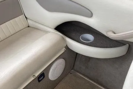 Slide: The Image of 2007 Stingray 195FX boat interior with beige seating and cup holder. - 23