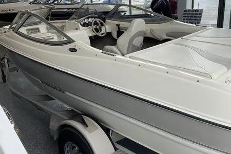 Slide: The Image of 2007 Stingray 195FX boat in showroom, featuring sleek design and comfortable seating. - 5