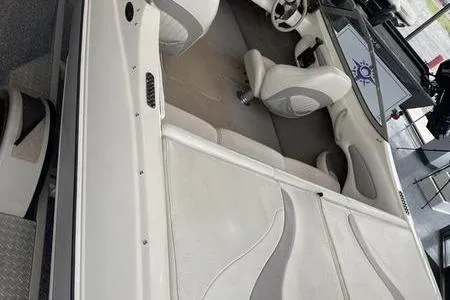 Slide: The Image of 2007 Stingray 195FX boat interior with white seating and steering wheel. - 8