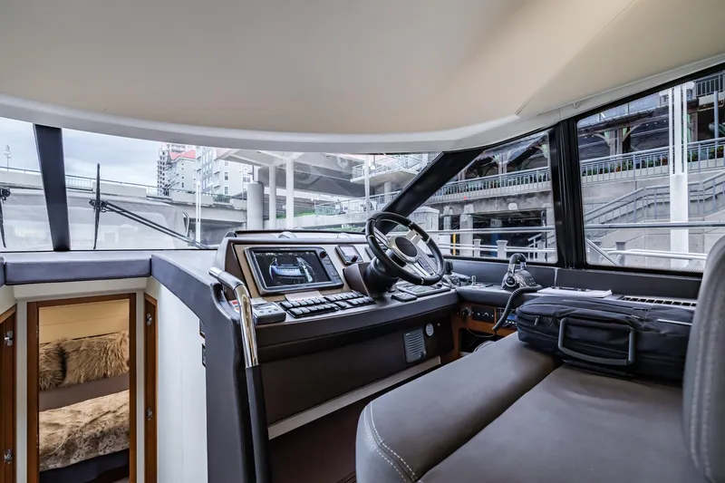 Slide: The Image of Interior view of 2013 Prestige 500 Fly yacht cockpit with modern controls and seating. - 21