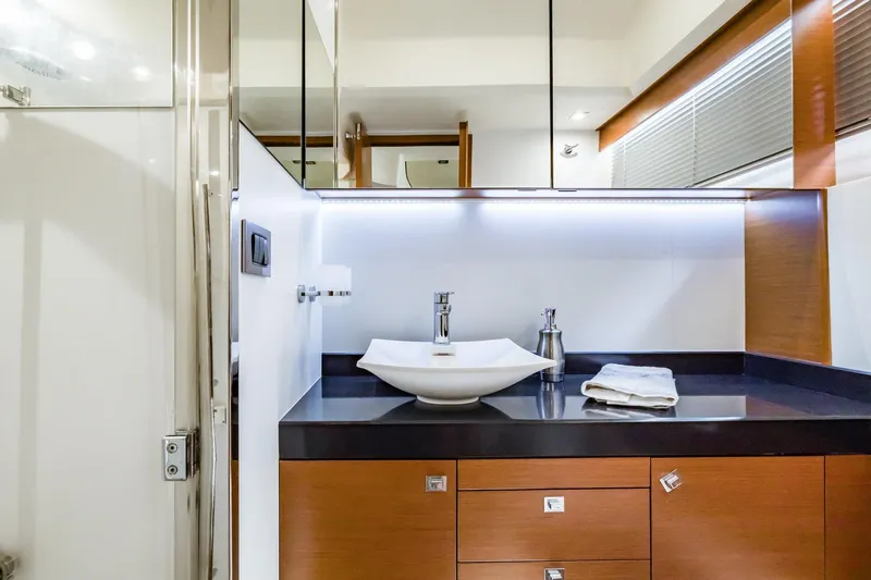 Slide: The Image of Luxurious bathroom interior of 2013 Prestige 500 Fly yacht with modern sink and wooden cabinetry. - 27