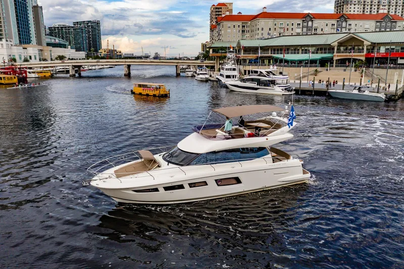 Slide: The Image of Luxury 2013 Prestige 500 Fly yacht cruising in a bustling urban marina. - 3