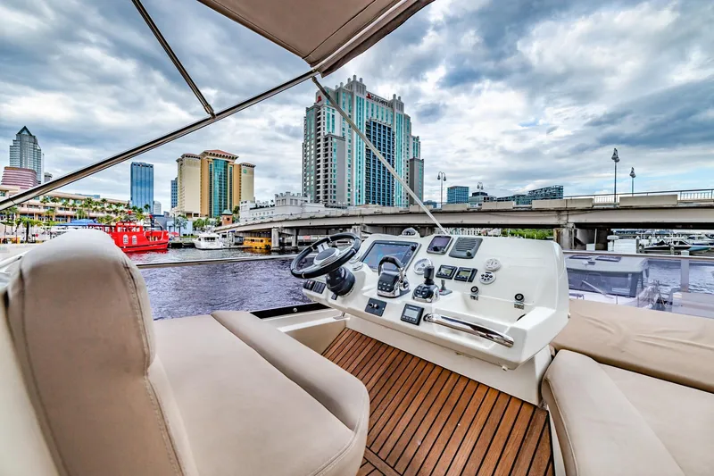Slide: The Image of Flybridge view of 2013 Prestige 500 Fly yacht with city skyline backdrop. - 32